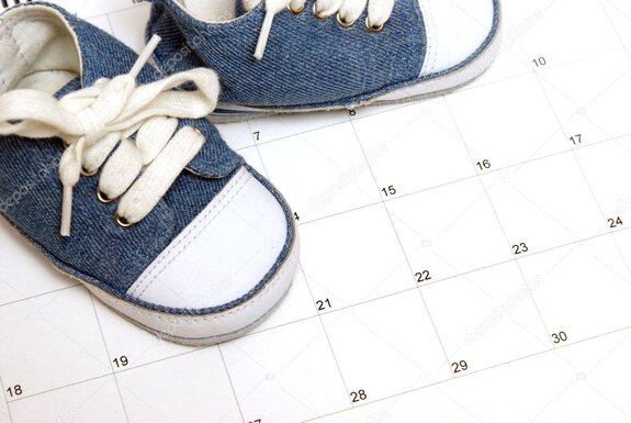 Printed parenting schedule and calendar on a desk with pen and glasses