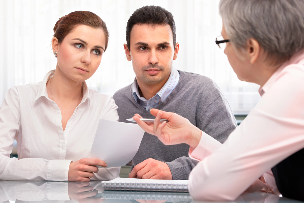 Business owners reviewing documents with a professional advisor