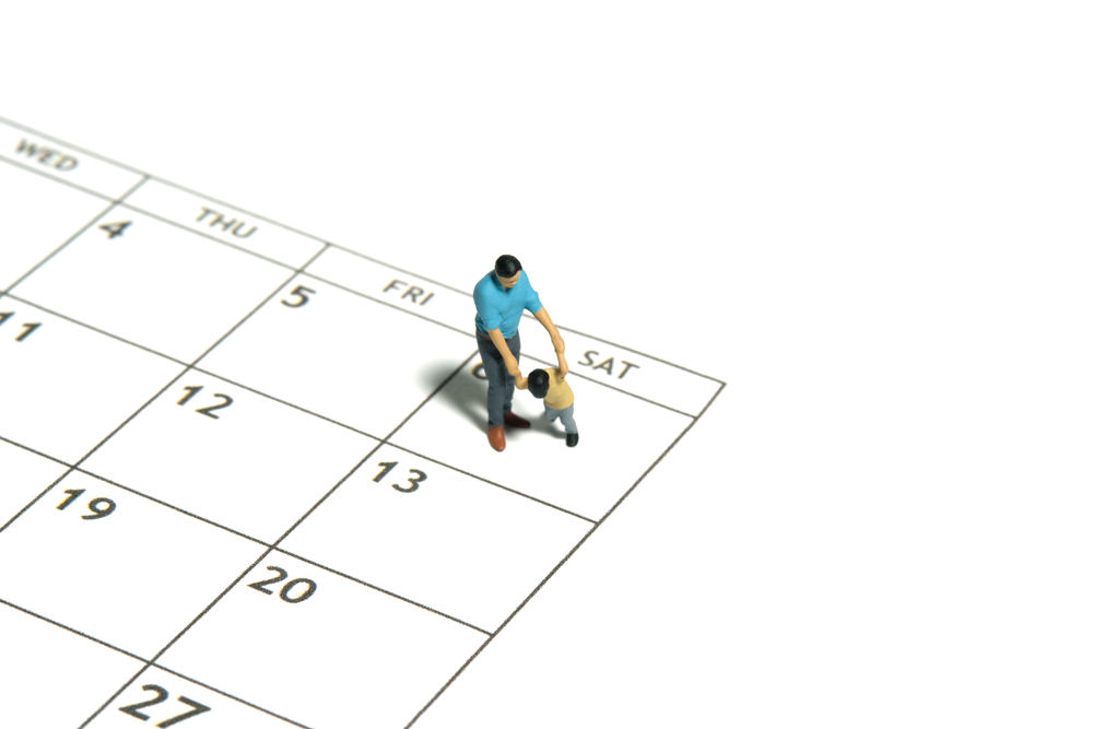 Printed parenting schedule and calendar laid out on a desk