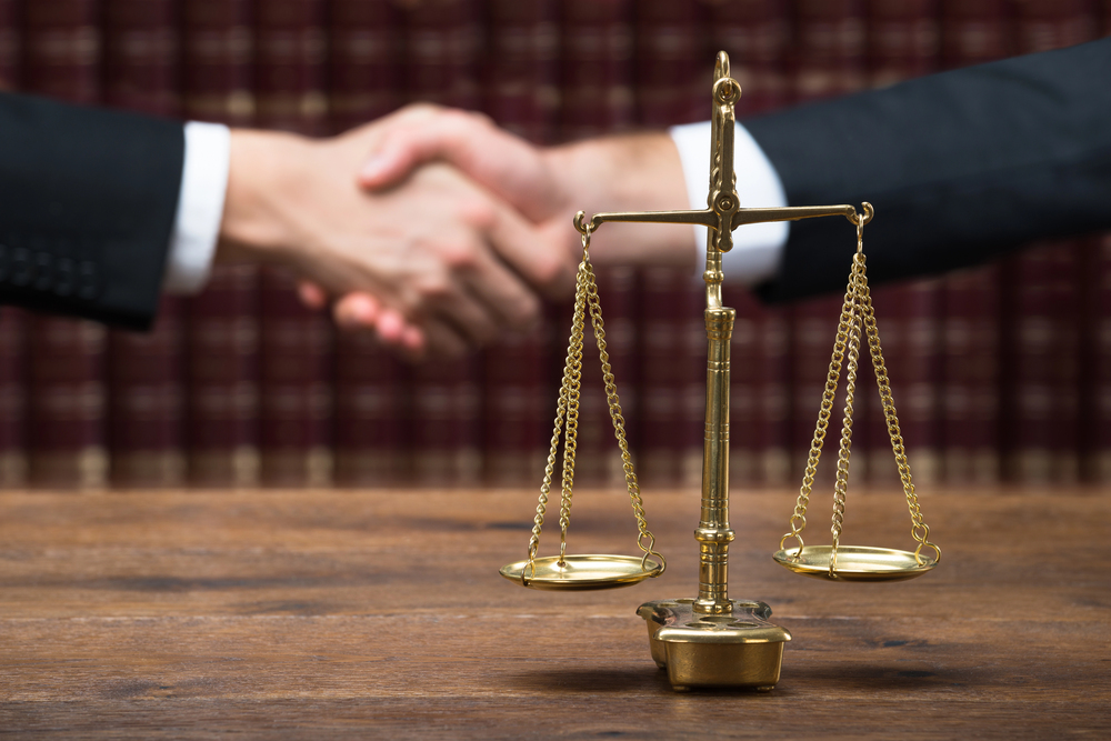 Attorney’s hands folded on a desk conveying professionalism and integrity